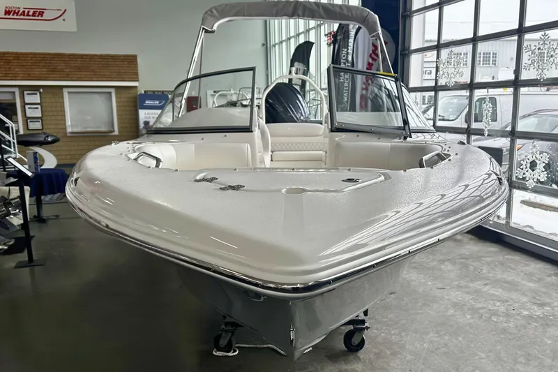 Slide: The Image of 2026 Key West 203 DFS boat displayed in showroom with sleek design and modern features. - 26