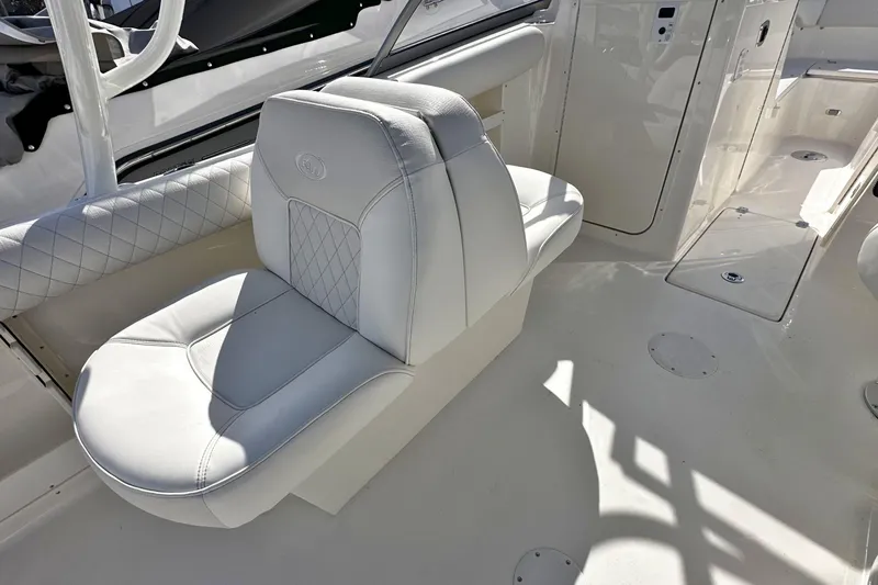 Slide: The Image of 2026 Key West 239 DFS boat interior with white cushioned seating and sleek design. - 11