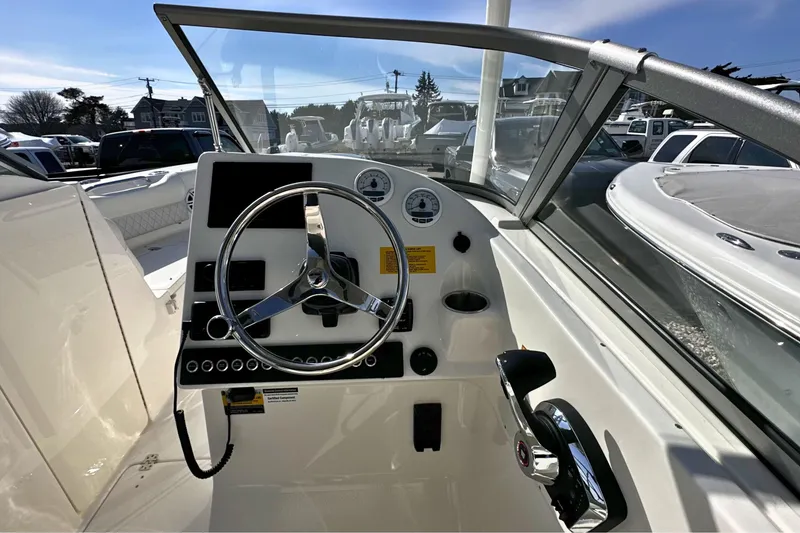 Slide: The Image of 2026 Key West 239 DFS boat dashboard with steering wheel and controls. - 14