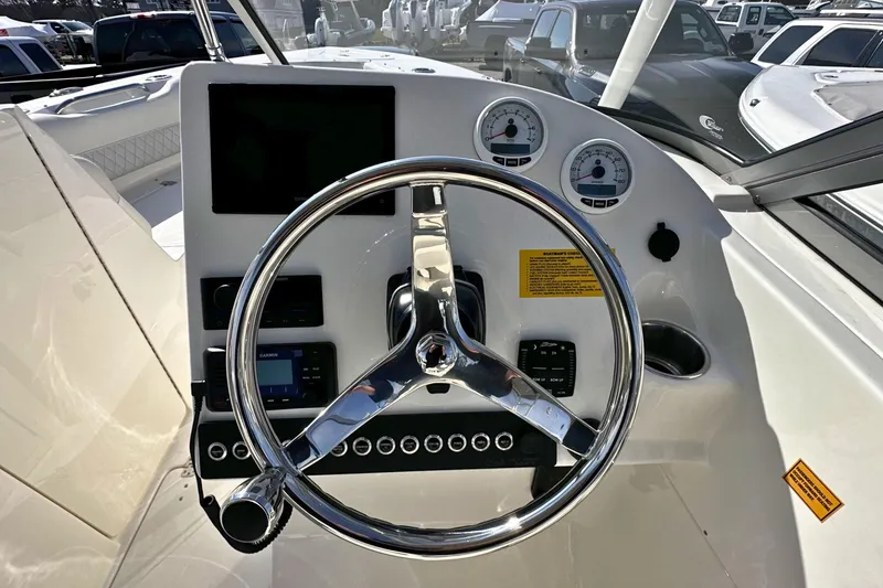 Slide: The Image of Steering console of 2026 Key West 239 DFS boat with gauges and controls. - 15