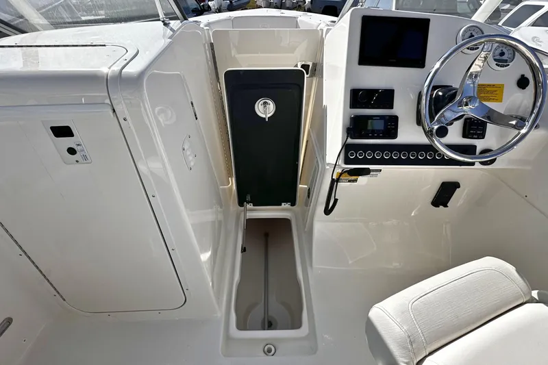 Slide: The Image of 2026 Key West 239 DFS boat interior with steering wheel and control panel. - 16