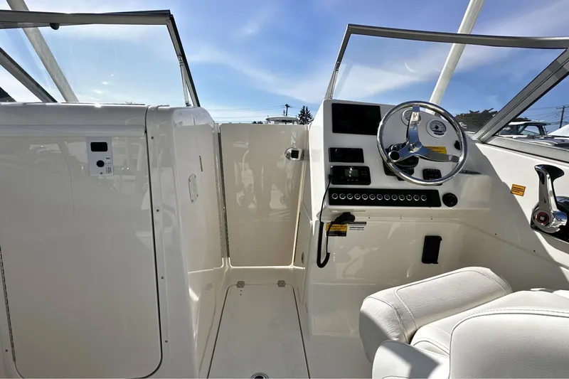 Slide: The Image of Interior view of 2026 Key West 239 DFS boat cockpit with steering wheel and controls. - 20