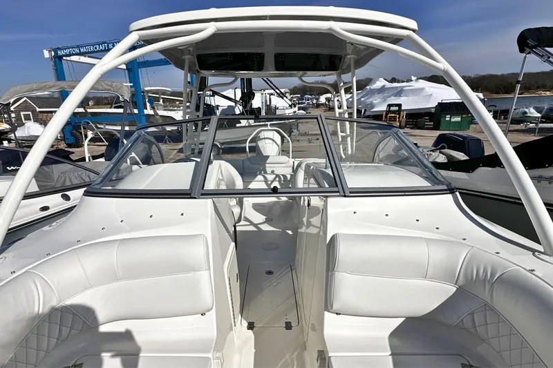 Slide: The Image of 2026 Key West 239 DFS boat with white seating and sleek design at a marina. - 21