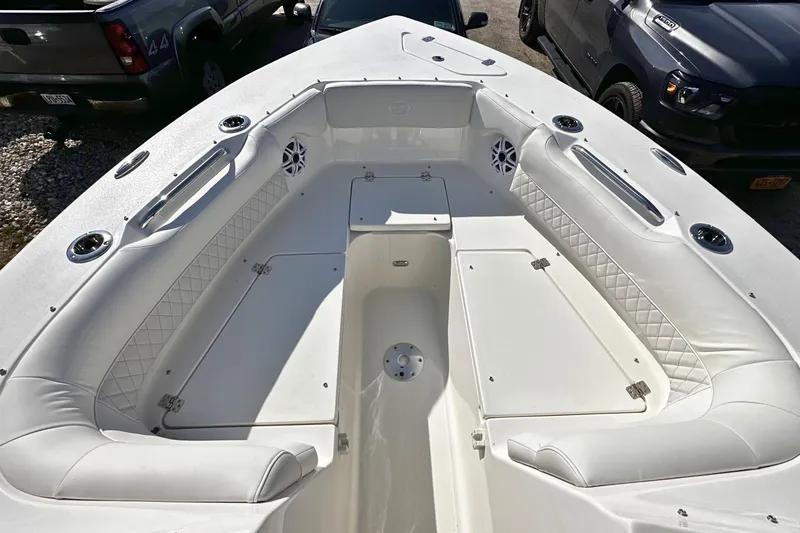 Slide: The Image of 2026 Key West 239 DFS boat interior with white cushioned seating and storage compartments. - 22