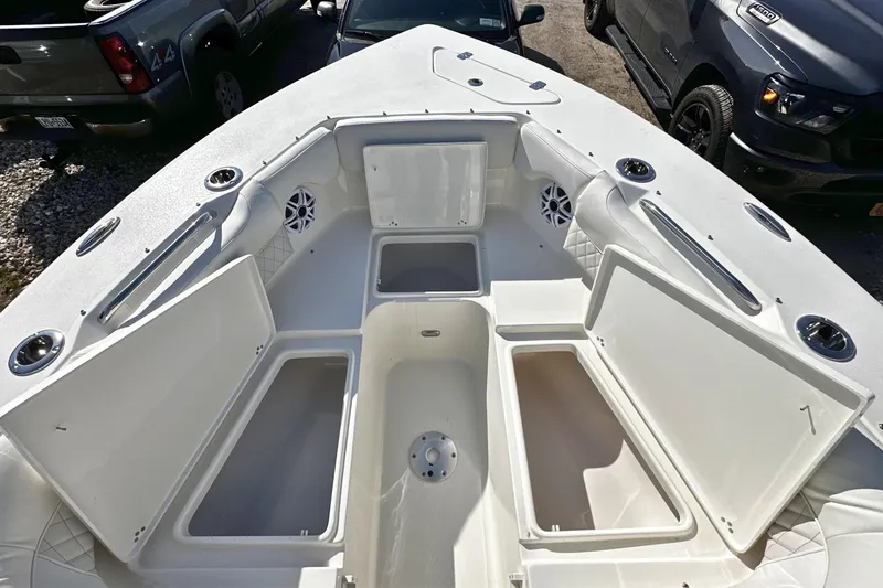Slide: The Image of 2026 Key West 239 DFS boat with open storage compartments and seating area. - 23