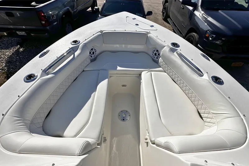 Slide: The Image of 2026 Key West 239 DFS boat interior with white cushioned seating and cup holders. - 24