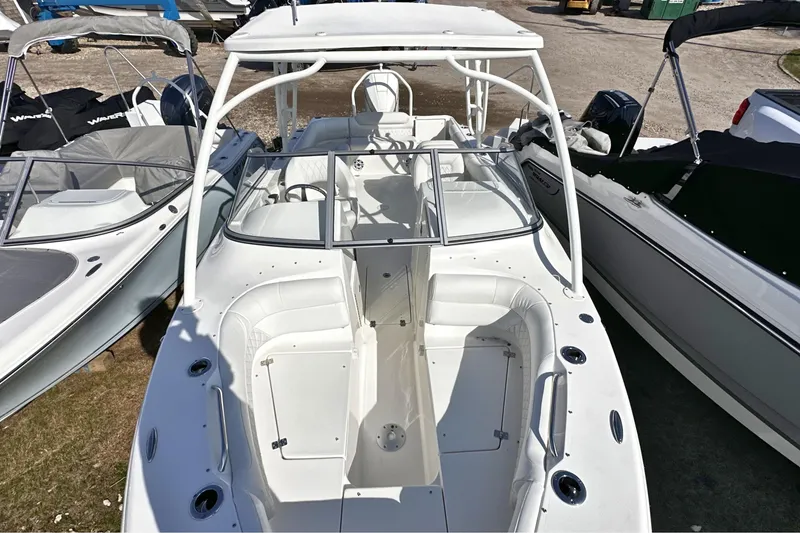 Slide: The Image of 2026 Key West 239 DFS boat with white interior, docked among other boats. - 26