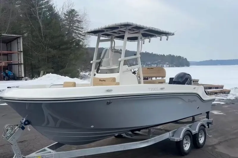 Slide: The Image of 2026 Bayliner Trophy T20CC boat on trailer, snowy lakeside background. - 11