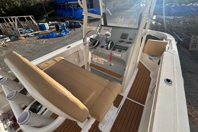 Slide: The Image of 2026 Bayliner Trophy T20CC boat interior with helm, seating, and rod holders. - 7