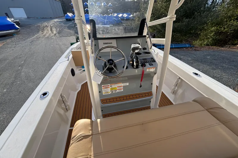Slide: The Image of 2026 Bayliner Trophy T20CC boat interior with steering console and seating. - 8