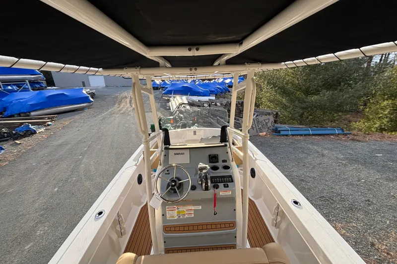 Slide: The Image of 2026 Bayliner Trophy T20CC boat interior with steering console and canopy. - 9