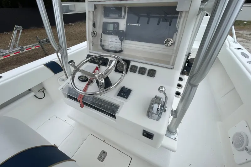 Slide: The Image of 2004 SeaVee 320i Cuddy boat helm with steering wheel and navigation controls. - 10