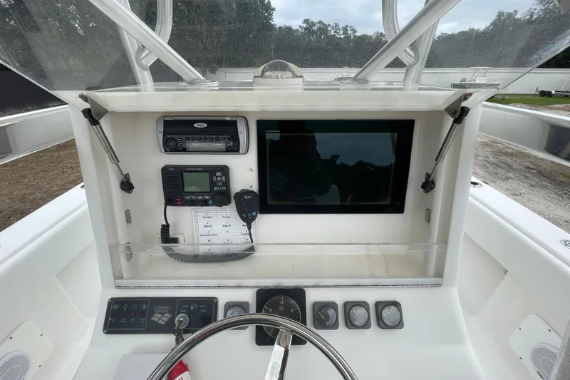 Slide: The Image of 2004 SeaVee 320i Cuddy boat dashboard with navigation and communication equipment. - 11