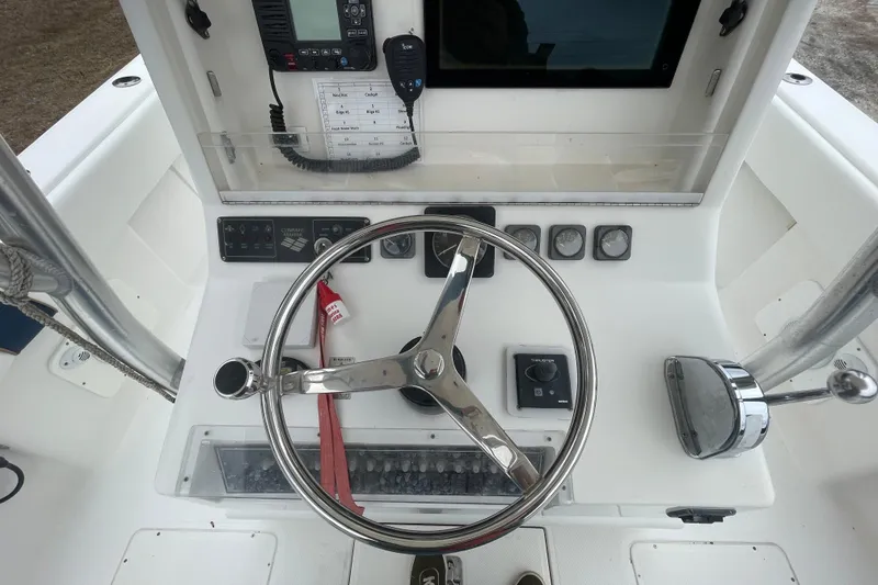 Slide: The Image of 2004 SeaVee 320i Cuddy helm with steering wheel, gauges, and navigation equipment. - 12