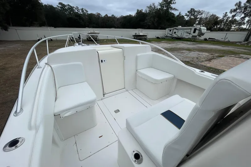 Slide: The Image of 2004 SeaVee 320i Cuddy boat interior with white seating and open deck. - 15