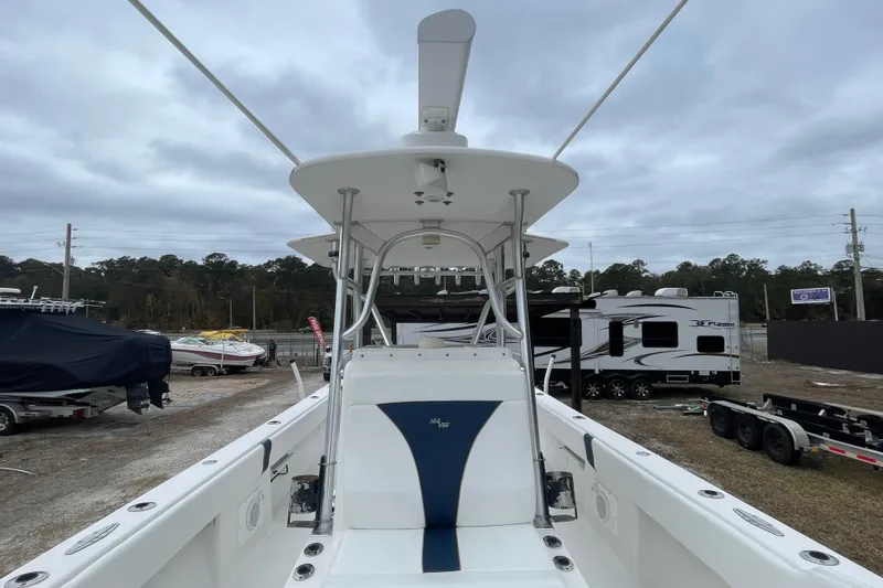 Slide: The Image of 2004 SeaVee 320i Cuddy boat, white interior, parked outdoors with trailers and RVs nearby. - 17