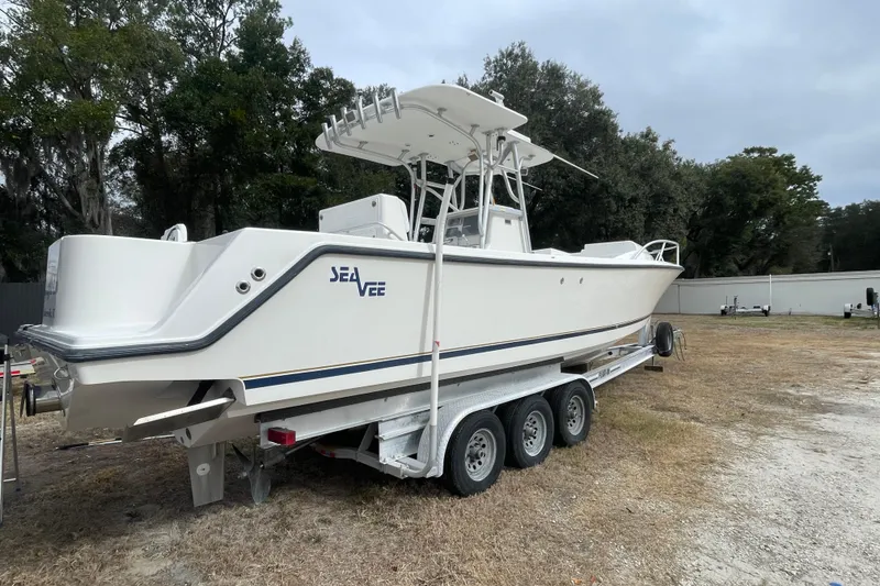 Slide: The Image of 2004 SeaVee 320i Cuddy boat on trailer, parked outdoors. - 2