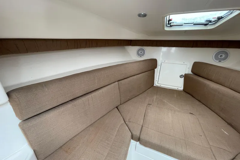 Slide: The Image of 2004 SeaVee 320i Cuddy interior with brown cushions and overhead hatch. - 21