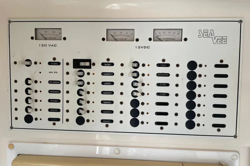 Slide: The Image of Electrical panel of a 2004 SeaVee 320i Cuddy boat, featuring 120 VAC and 12 VDC controls. - 25