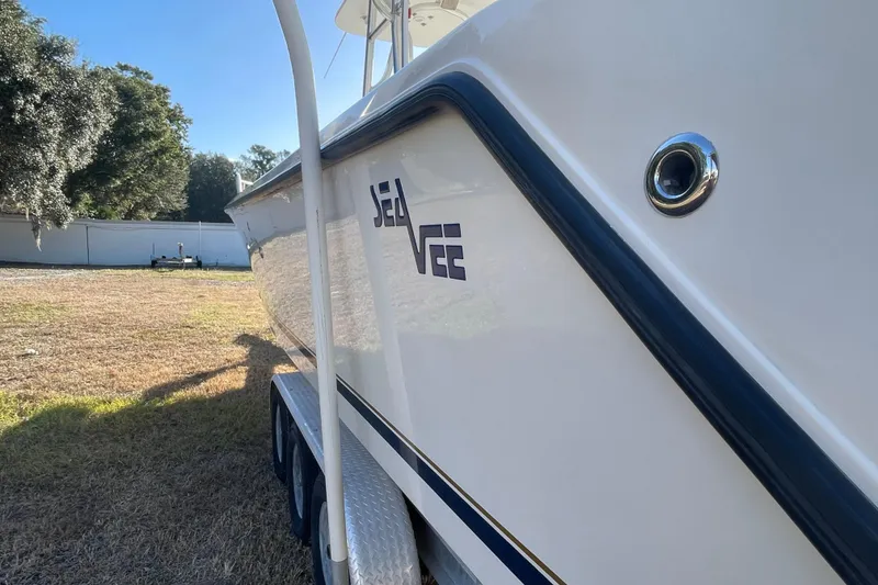 Slide: The Image of 2004 SeaVee 320i Cuddy boat side view, parked on grass. - 4