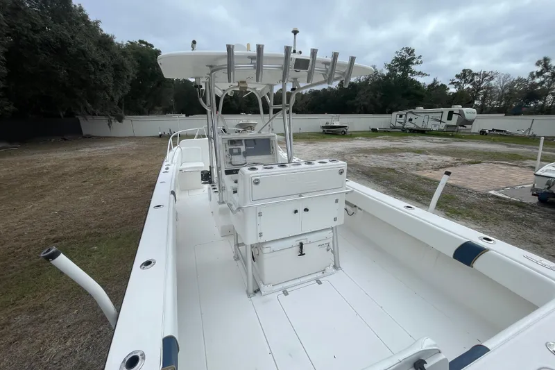 Slide: The Image of 2004 SeaVee 320i Cuddy boat with center console, parked outdoors on grassy area. - 6