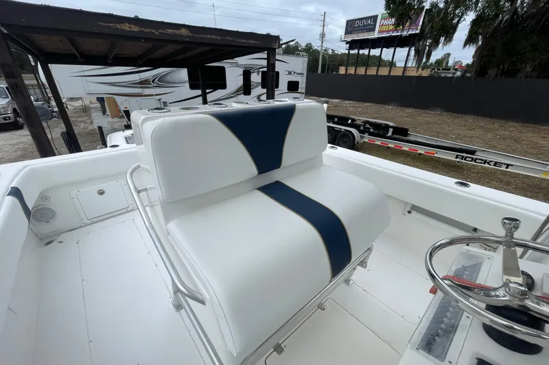 Slide: The Image of 2004 SeaVee 320i Cuddy boat interior with white and blue seating. - 7
