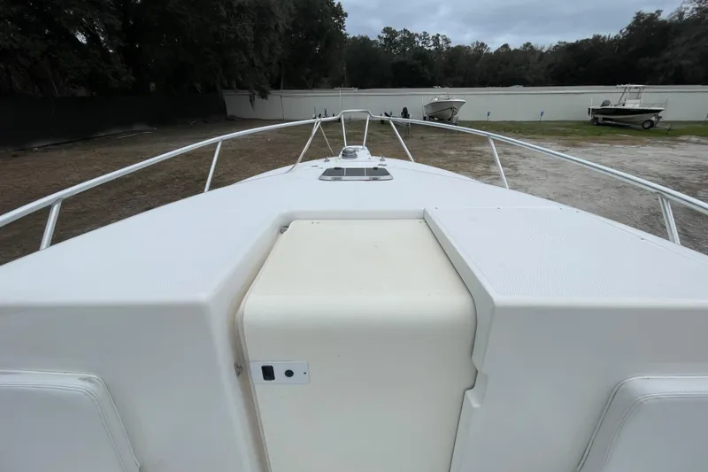 Slide: The Image of 2004 SeaVee 320i Cuddy boat deck, featuring spacious layout and railing. - 8