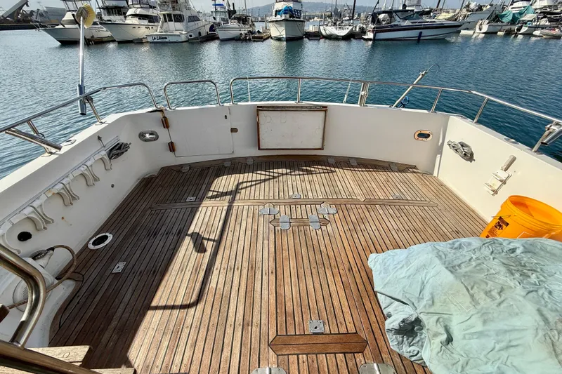 Slide: The Image of Deck of 1990 Mikelson 42 yacht with wooden flooring, docked at marina. - 13