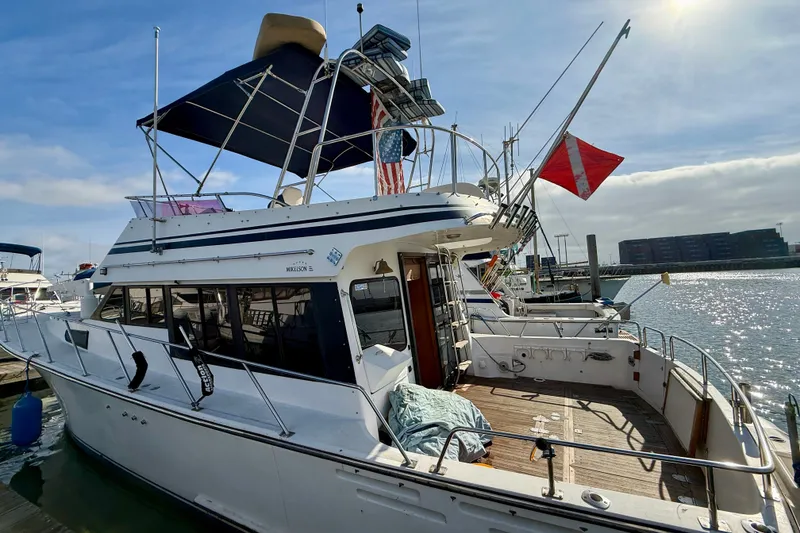 Slide: The Image of 1990 Mikelson 42 yacht docked at marina under sunny sky. - 2