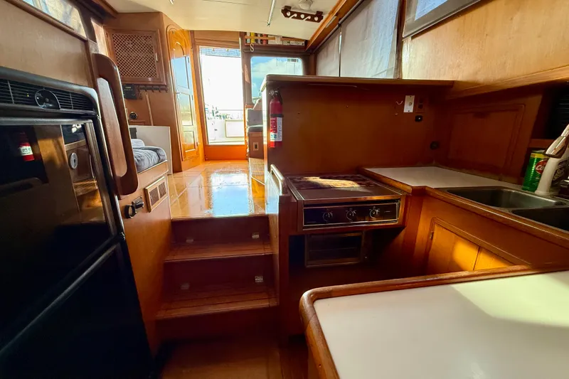 Slide: The Image of Interior of 1990 Mikelson 42 yacht with kitchen and seating area. - 20