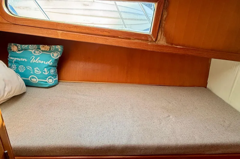 Slide: The Image of Cozy cabin interior of 1990 Mikelson 42 yacht with Cayman Islands pillow. - 24