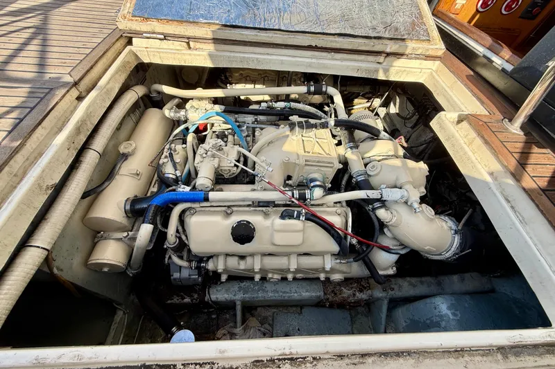 Slide: The Image of Engine compartment of a 1990 Mikelson 42 boat, showcasing detailed mechanical components. - 31