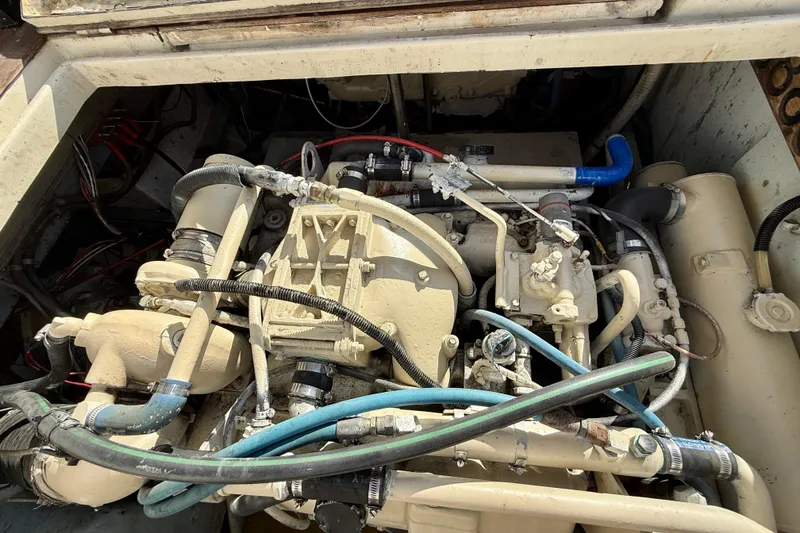 Slide: The Image of Engine compartment of a 1990 Mikelson 42 boat, showcasing intricate mechanical components. - 32