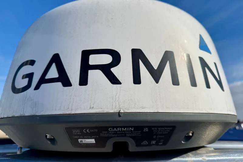 Slide: The Image of Garmin marine radar scanner on a 1990 Mikelson 42 boat under blue sky. - 35