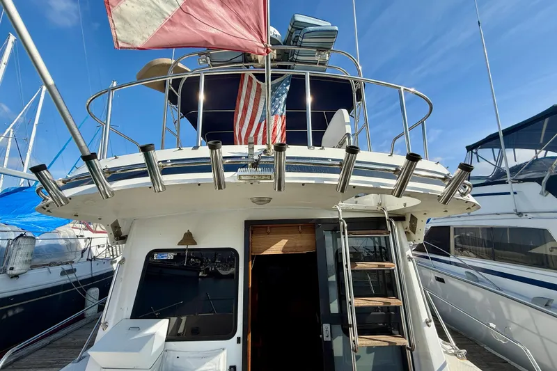 Slide: The Image of 1990 Mikelson 42 yacht stern view with fishing rod holders and American flag. - 4