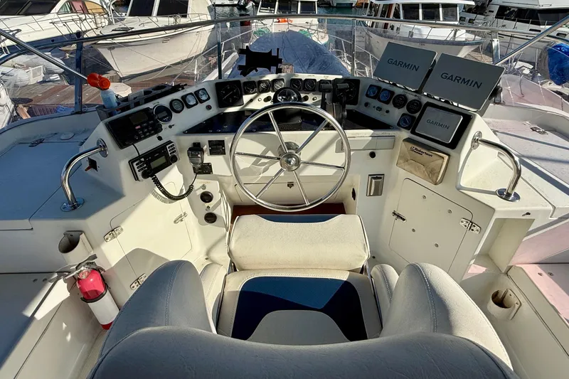 Slide: The Image of Cockpit of a 1990 Mikelson 42 yacht with steering wheel and navigation equipment. - 5