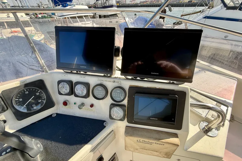 Slide: The Image of Control panel of a 1990 Mikelson 42 boat with Garmin displays and gauges. - 6