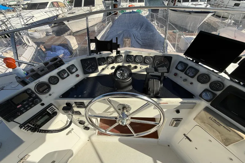 Slide: The Image of Control panel of a 1990 Mikelson 42 yacht with steering wheel and navigation instruments. - 7