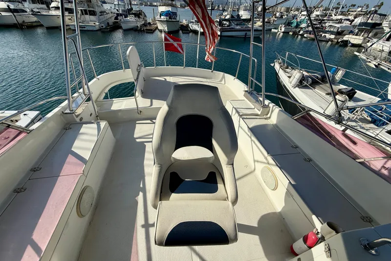 Slide: The Image of 1990 Mikelson 42 yacht deck with seating, docked in a marina. - 9