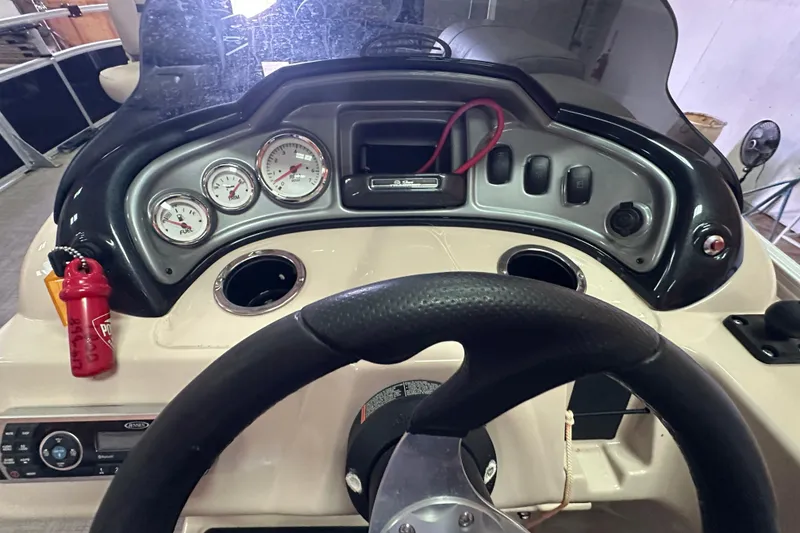 Slide: The Image of 2019 Sun Tracker Fishin' Barge 20 DLX dashboard with gauges and steering wheel. - 11