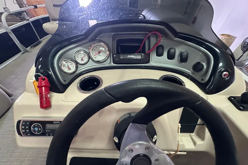Slide: The Image of 2019 Sun Tracker Fishin' Barge 20 DLX dashboard with steering wheel and gauges. - 14