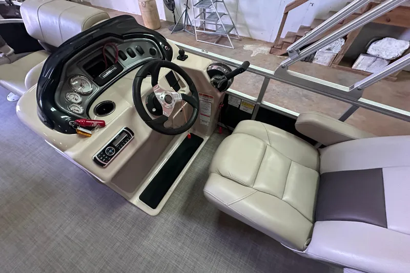 Slide: The Image of 2019 Sun Tracker Fishin' Barge 20 DLX helm with steering wheel and gauges. - 17