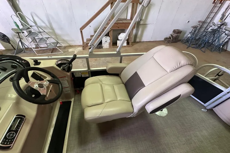 Slide: The Image of 2019 Sun Tracker Fishin' Barge 20 DLX interior with steering wheel and captain's chair. - 18
