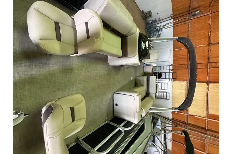 Slide: The Image of 2019 Sun Tracker Fishin' Barge 20 DLX interior with beige seating and canopy. - 6