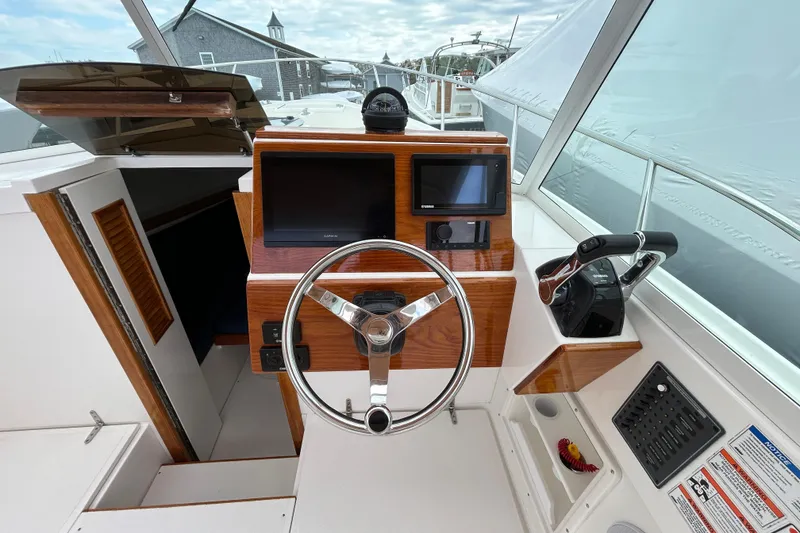 Slide: The Image of Cockpit of 2019 Limestone 26 boat with steering wheel and navigation controls. - 12