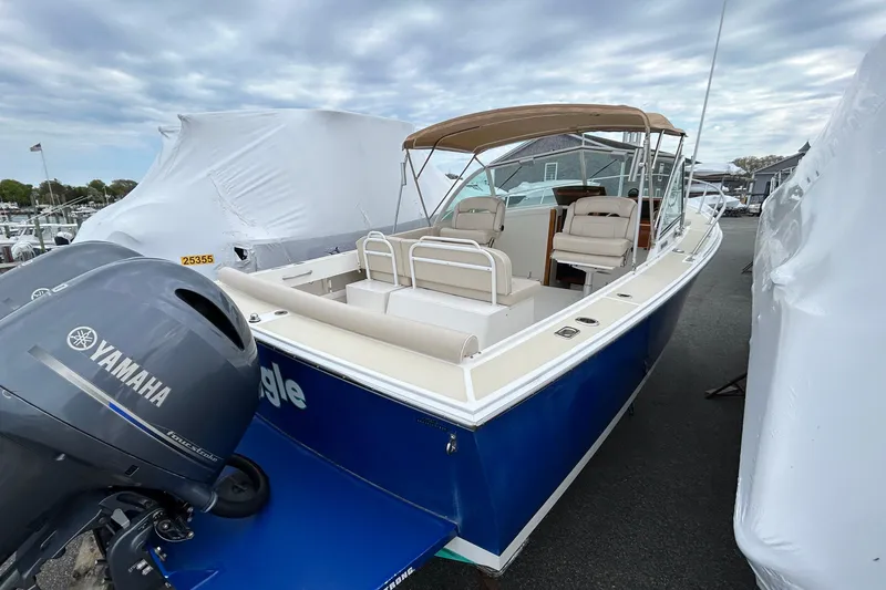 Slide: The Image of 2019 Limestone 26 boat with Yamaha engine, docked under cloudy skies. - 16