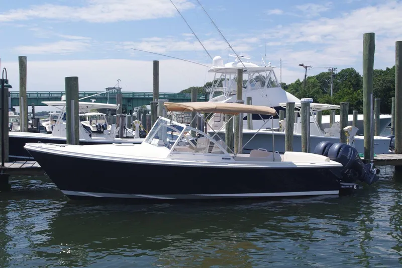 Slide: The Image of 2019 Limestone 26 boat docked at marina with clear skies. - 2