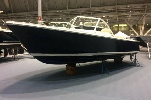 Slide: The Image of 2019 Limestone 26 boat displayed indoors on stands. - 6
