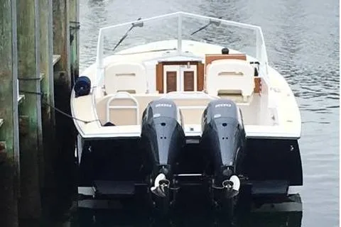 Slide: The Image of 2019 Limestone 26 boat with dual engines docked at a marina. - 9