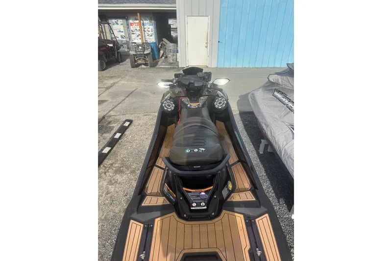 Slide: The Image of 2023 Kawasaki Jetski Ultra 310LX parked outdoors, showcasing sleek design and advanced features. - 3